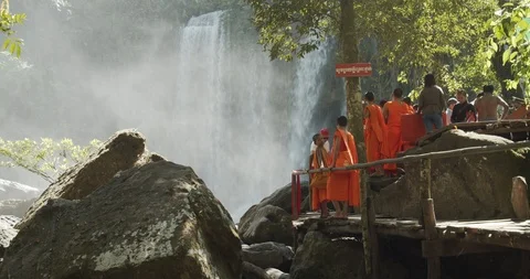Cambodia waterfall with monks Stock Footage 99814641