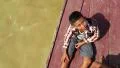 Cambodian boy on the boat which sails to the Tonle Sap lake in Cambodia HD Footage