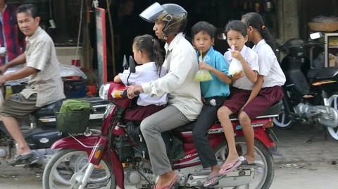 Cambodian Family Going To School On A Motorcycle Stock Footage