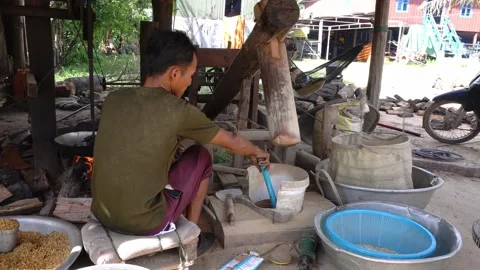 Cambodian man roasts and flatten rice in khmer flat-rice making process Stock Footage 140897151