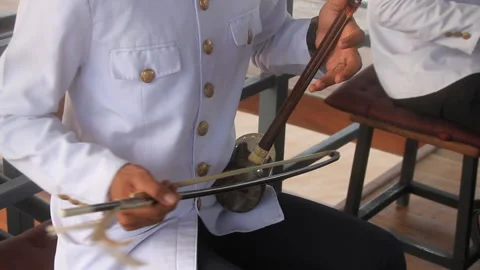 Cambodian musical string instrument called Tro in action medium close shot Stock Footage 130667208