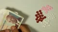 Cambodian Riel KHR, Counting Drugs and Money, Health Care, Colorful Pills HD Footage