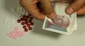 Cambodian Riel KHR, Counting Drugs and Money, Health Care, Colorful Pills HD Footage