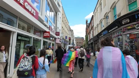 Cambridge Pride Parade marching through Cambridge City Centre - Flags everywhere Stock Footage 338020029