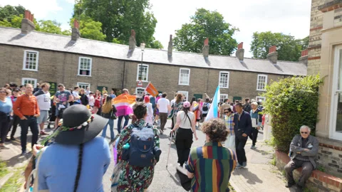 Cambridge Pride walking in the parade with supporters looking on. Stock Footage 338016887