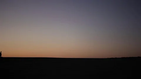 Camel caravan silhouette at sunset Видео 77378779