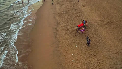 Camel driver with his camel on a beach in India, aerial drone view 4k Stock Footage 134987979