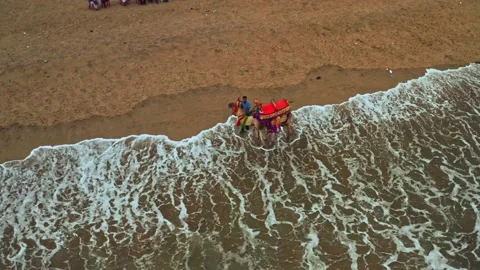 Camel driver with his camel on a beach in India, aerial drone view 4k Stock Footage 134992202