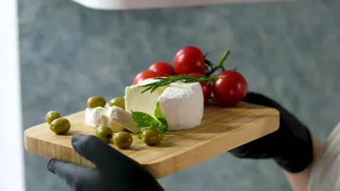 Camembert, Cooking process, Step by step worker at a craft cheese factory turns Stock Footage 302819710
