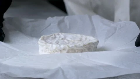 Camembert, Cooking process, Step by step worker at a craft cheese factory turns Stock Footage 302820159