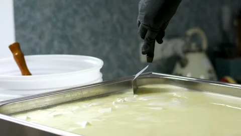 Camembert, Cooking process, Step by step worker at a craft cheese factory turns Stock Footage 302821716