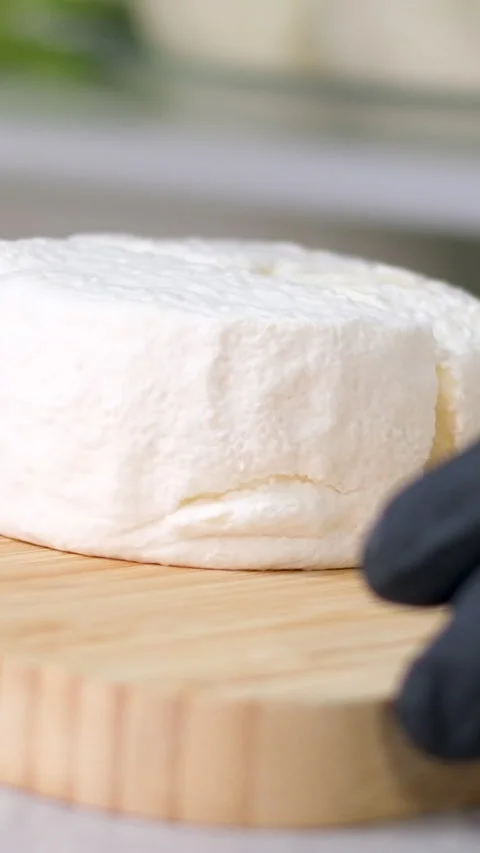 Camembert, Cooking process, Step by step worker at a craft cheese factory turns Stock Footage 306760056