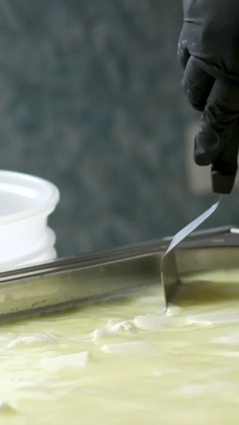 Camembert, Cooking process, Step by step worker at a craft cheese factory turns Stock Footage 306760805