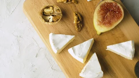 Camembert, walnuts and halves of fig Stock Footage 140372232