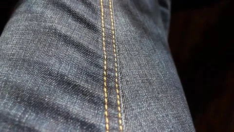 The camera advances the seam of jeans, close-up Stock Footage 135732601
