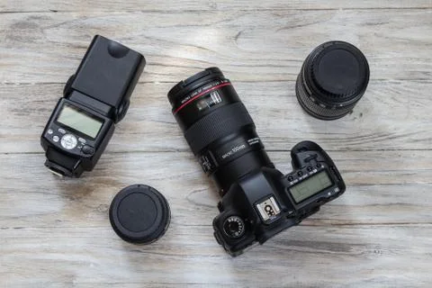 Camera and camera lens well organized over wooden background, top view Stock Photos