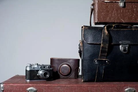 Camera and carrying case on old suitcase Stock Photos