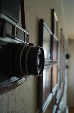 Camera and frames on the wall. Camera lens on the wall. Stock Photos