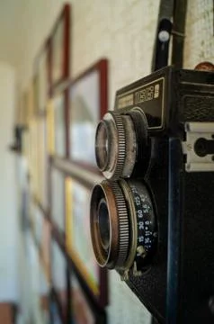 Camera and frames on the wall. Camera lens on the wall. Stock Photos