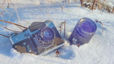 Camera and lens on the snow in the forest Stock Footage 99213234