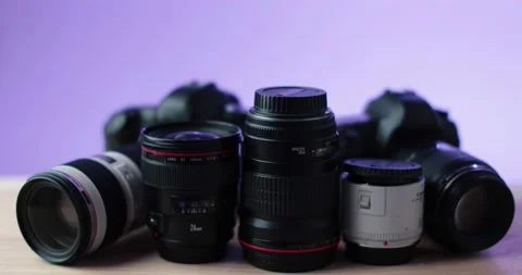 Camera and photo lense camera equipment with purple background in studio Stock Footage 237546461