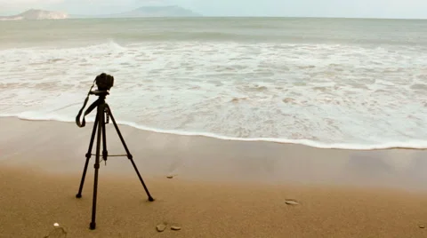 Camera and tripod on a beach. Stock Footage 55727899