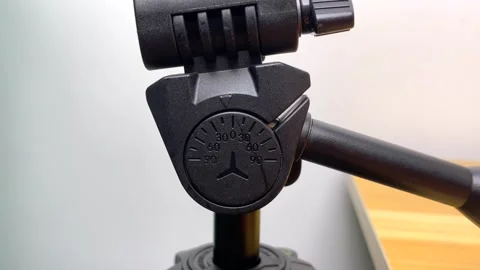 Camera angle indicator tilt up shot on black camera tripod close up shot Video stock 249890814