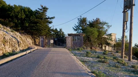 Camera approaching abandoned checkpoint on mountain road Stock Footage 289139606