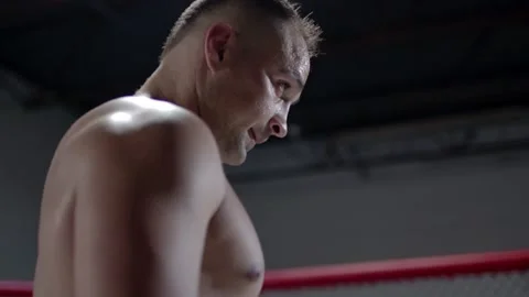 Camera is approaching Muscular MMA fighter inside the octagon. Stock Footage 155657618
