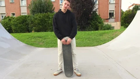 Camera Approaching a Skater Posing with His Skateboard at the Skate park Stock Footage 285765955