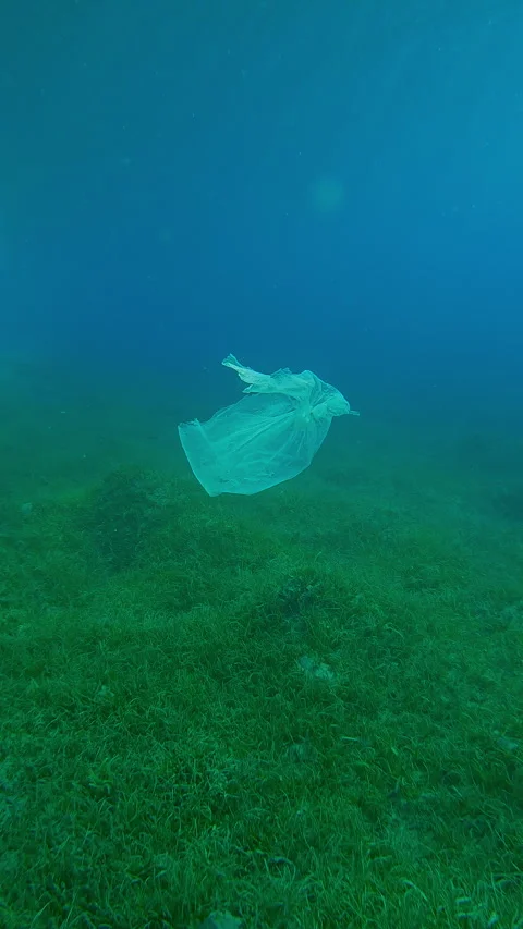 Camera approaching to white plastic bag floating on blue water column above Stock Footage 336926368
