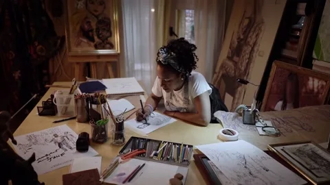 Camera approaching the young artist drawing a portrait of a man sitting at th Stock Footage 152344743