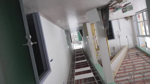 Camera arc captures hallways symmetry and neat flooring 動画素材 313833042