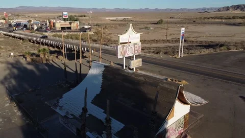 Camera arcs around abandoned motel sign Stock Footage 142397993