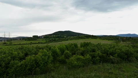 Camera ascending from a field to show a mountain Stock Footage 310575500