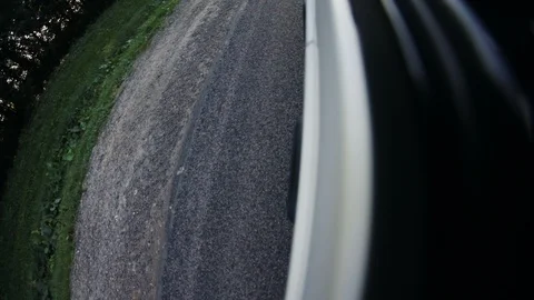 Camera attached on the side of the car rolling up and down opening views of the Stock Footage 100834443