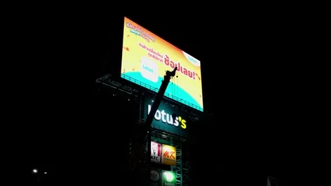 Camera backs out revealing this LED Billboard of Lotus's super market, ads Stock Footage 256877182