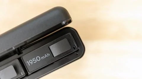 Camera Battery 1950 mAh Inside Charging Case on Wooden Table Stock Photos