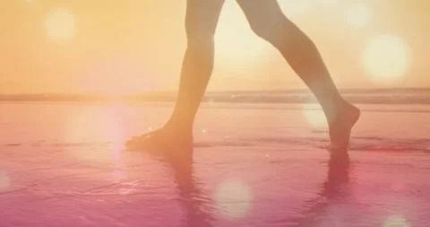 Camera beginning low, lower legs walking, flat contacts on wet sand, toe Stock Footage 332286122