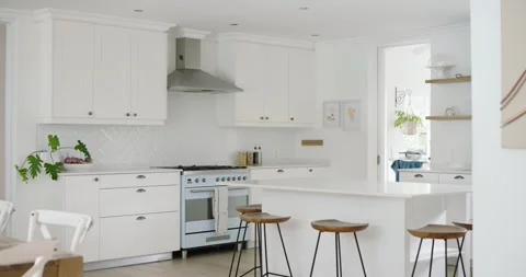 Camera is beginning to pan right and zoom out, showing bright kitchen with Stock Footage 345508839