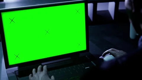 Camera behind man and green screen color on laptop display. Modern tech Stock Footage 283552933