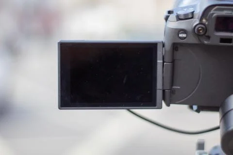 Camera with black screen overlooking a blurry street Stock Photos