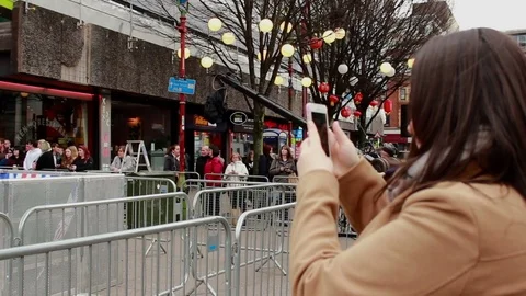 Camera boom moving on crane and woman taking a photo on a cell phone Stock Footage 71593769