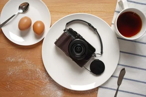 Camera on a breakfast table Stock Photos