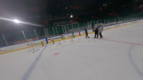 Camera captures jib with spotlight gliding above ice arena Stock Footage 303278747