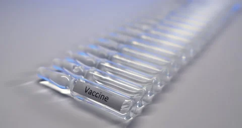 The camera captures the light illuminating the vaccine vials Stock Footage 149708930