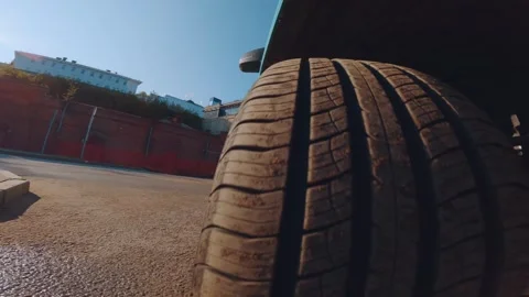 The camera captures the movement of the car from the wheel Stock Footage 284034113