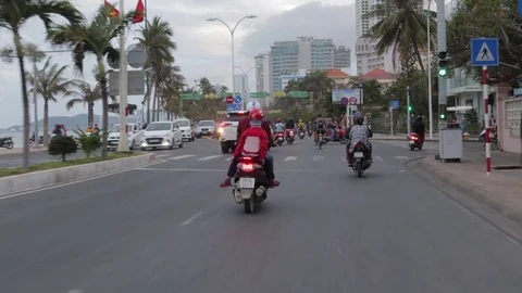 Camera captures passing motorbikes on the road in Nha Trang Stock Footage 124916608