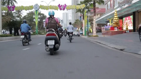 Camera captures passing motorbikes on the road in Nha Trang Stock-Footage 124916630