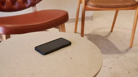 Camera captures a phone on a table. lost smart phone concept Stock Footage 340729773